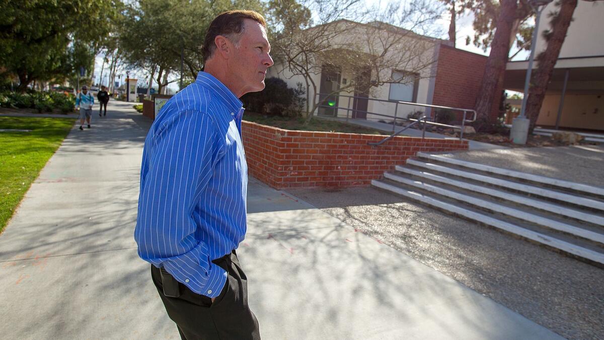 John Farmer, Orange Coast College's safety chief, walks the campus Thursday. As he approaches retirement, he said: "I really enjoyed it the whole time I’ve been here. It’s been a great ride, actually.”