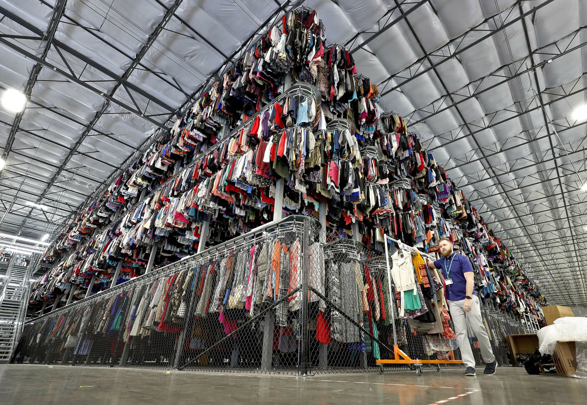 Garments on a three-level conveyor system at ThredUp