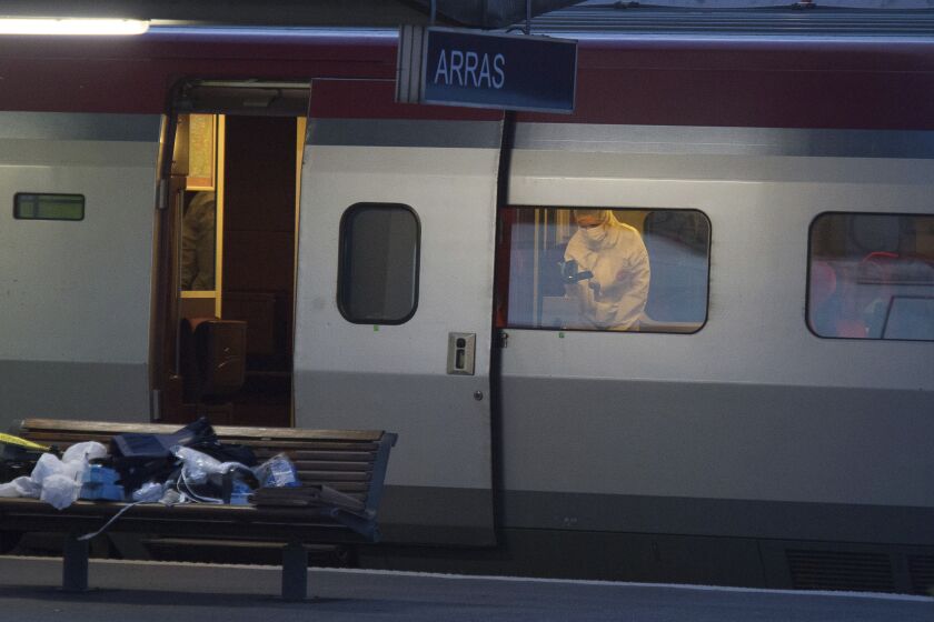 FILE - In this Aug.21, 2015 file photo, a police officer videos the crime scene inside a Thalys train at Arras train station, northern France, after a gunman opened fire with an automatic weapon. No one died, but few if any passengers on car 12 of a train to Paris would have reached their destination alive if the attack plot five years ago had gone off as planned, prosecutors contended at the month-long trial of an Islamic State operative. The proceedings end Thursday with the verdict. (AP Photo, File)