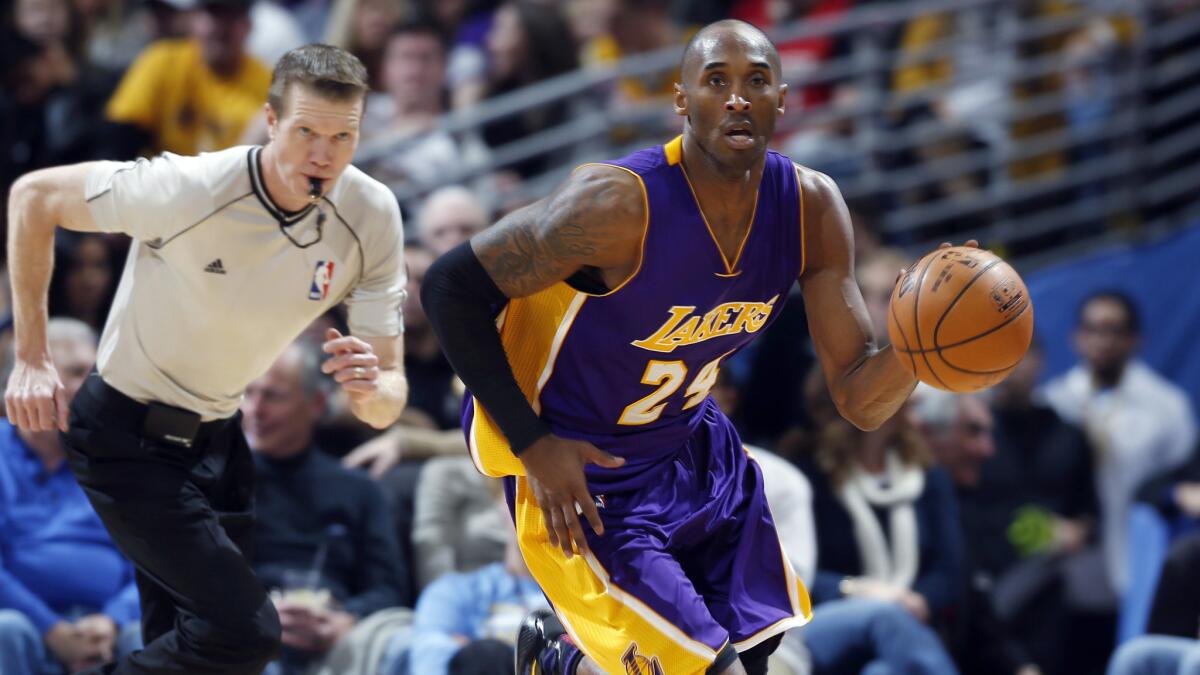 Lakers guard Kobe Bryant dribbles the ball during the fourth quarter of a 111-103 win over the Denver Nuggets on Tuesday.