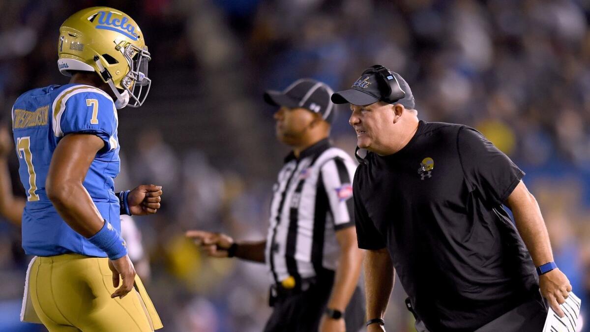 UCLA coach Chip Kelly talks with Dorian Thompson-Robinson during a game against Fresno State on Sept. 15.