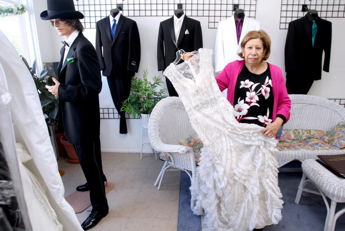 Alicia Fors, 69, of Montrose, and owner of Alicia's Formal & Tuxedo Shop, shows a dress she altered at her store in La Crescenta on Tuesday, Dec. 1, 2015. Fors will close her store for good at the end of the month after 30 years in business.
