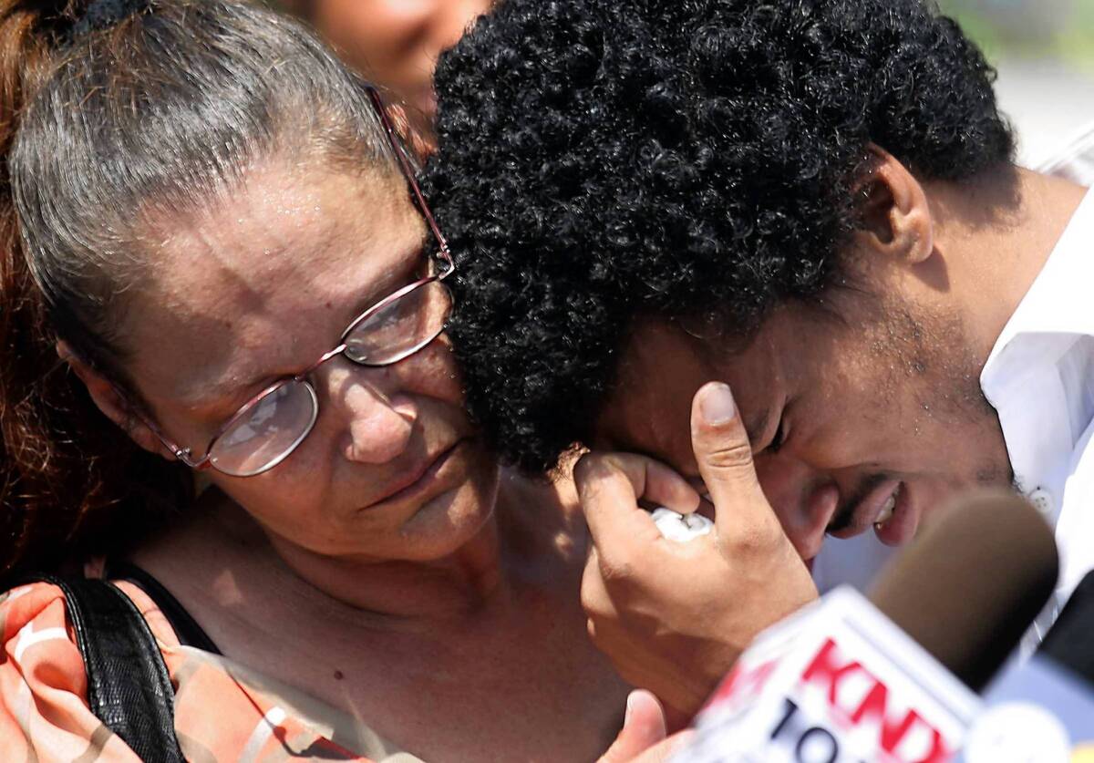 Ronald Weekley Jr., a college student from Venice, is comforted by his mother, Diana Holquin, when he breaks down during a news conference to talk about his encounter with Los Angeles police officers.