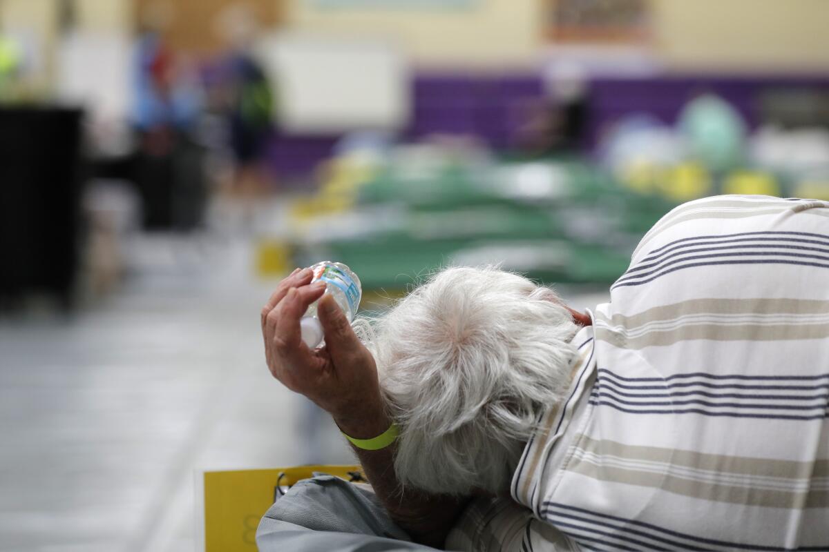 An evacuee lies on a cot at a shelter in Stuart, Fla., in September 2019 before Hurricane Dorian.