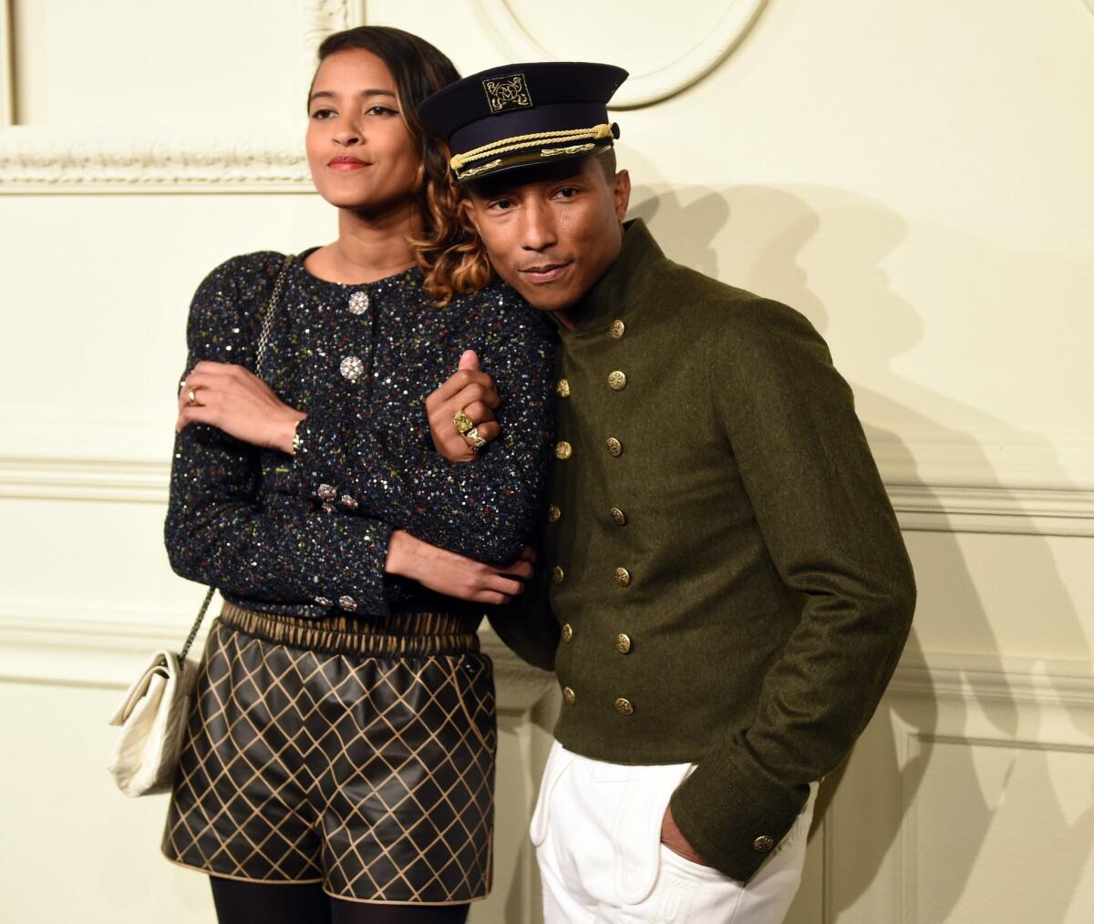 Pharrell Williams and his wife, Helen Lasichanh, arrive as Chanel presents its Paris-Salzburg 2014/15 Metiers d'Art Collection on Tuesday at Park Avenue Armory in New York City.