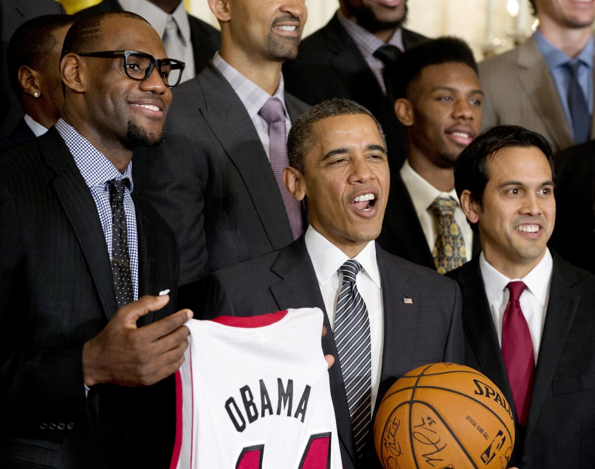 LeBron James and coach Erik Spoelstra present President Obama with a Heat jersey.