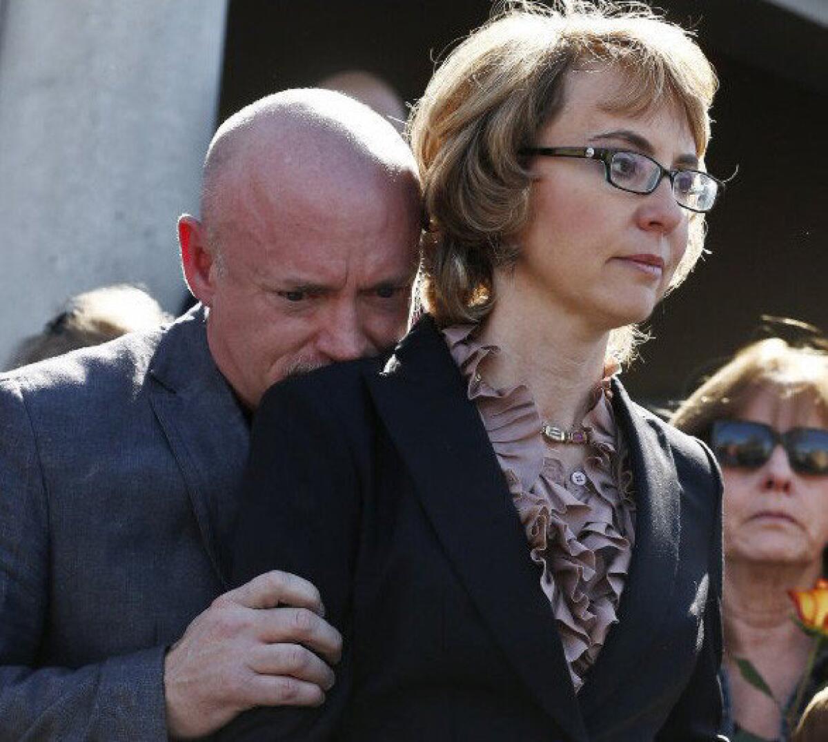 Former Rep. Gabrielle Giffords, right, with her husband Mark Kelly at a Tuscon rally in support of expanded background checks on gun control.