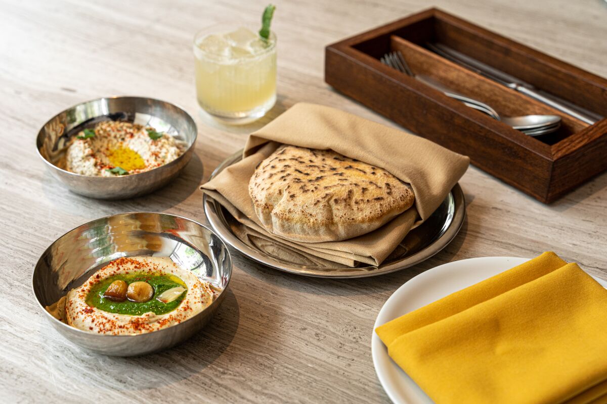 Fresh-baked pita and dips start most meals at Callie restaurant in East Village.