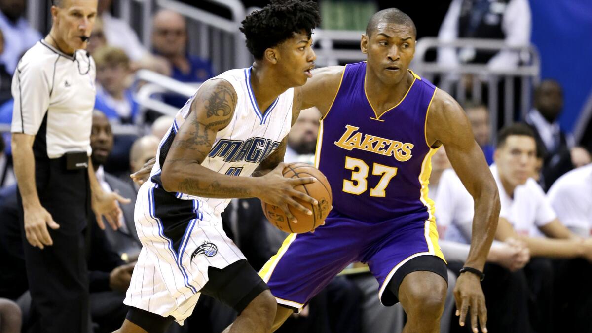 Lakers forward Metta World Peace guards Magic's Elfrid Payton as he drives in the first half Wednesday night in Orlando.