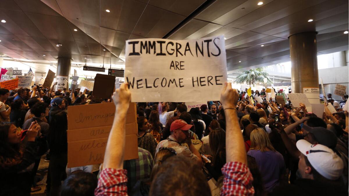 Protesters rally against President Trump's new travel restrictions on Sunday, January 29 at Los Angeles International Airport.