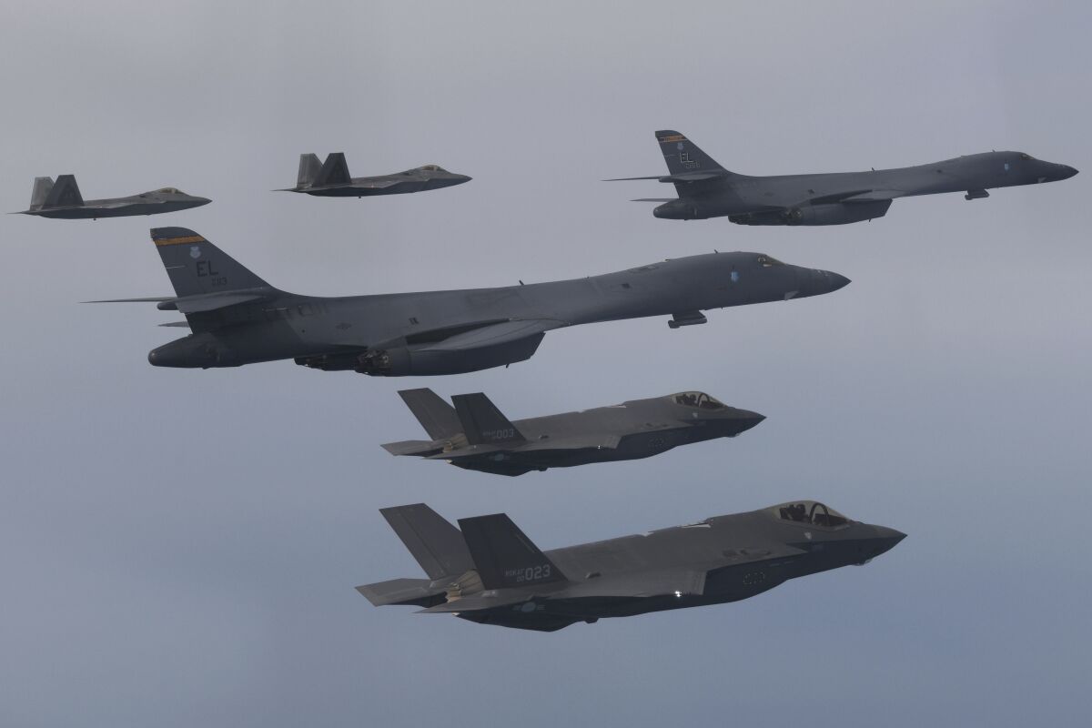 In this photo provided by South Korean Defense Ministry, U.S. Air Force B-1B bombers, center, F-22 fighter jets and South Korean Air Force F-35 fighter jets, bottom, fly over South Korea Peninsula during a joint air drill in South Korea, Wednesday, Jan. 1, 2023. North Korea on Thursday threatened the "toughest reaction" to the United States' expanding joint military exercises with South Korea to counter the North's growing nuclear weapons ambitions, claiming that the allies were pushing tensions to an "extreme red line." (South Korean Defense Ministry via AP)