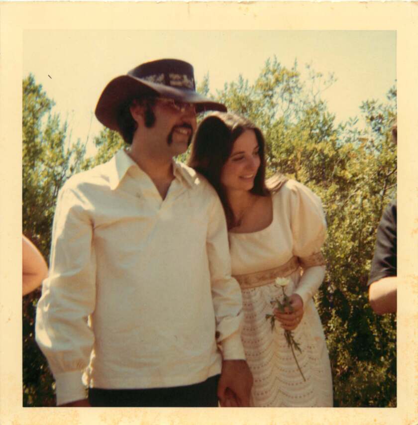 A man and a woman leaning on each other.