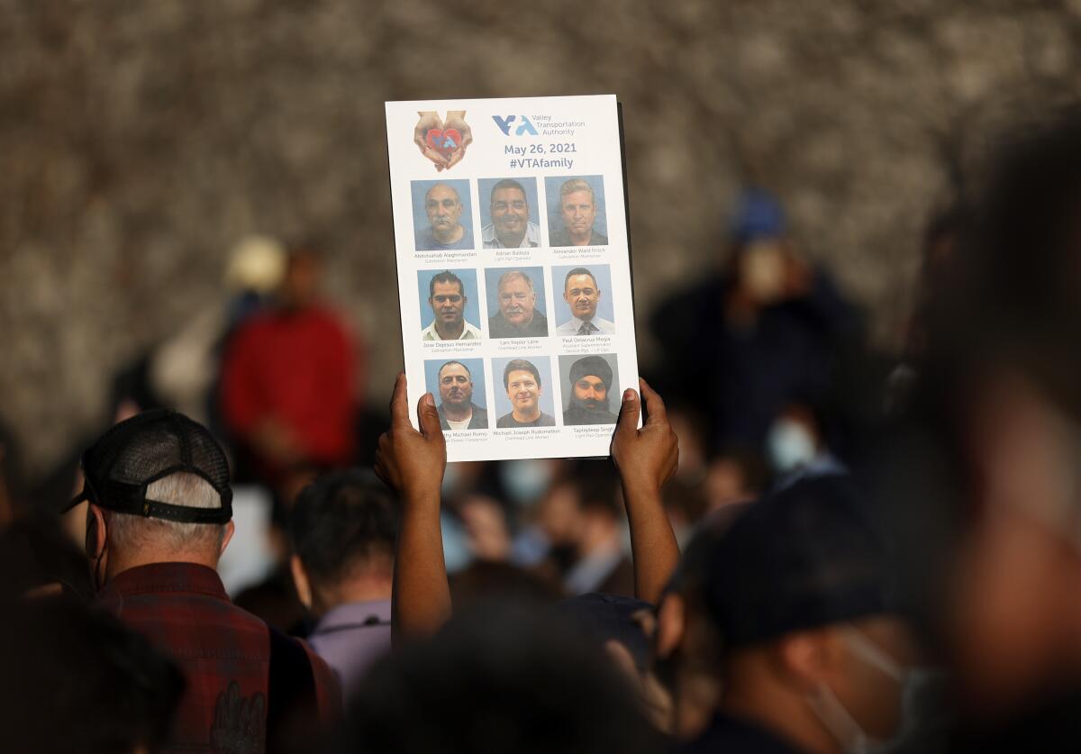 A mourner holds a sign 