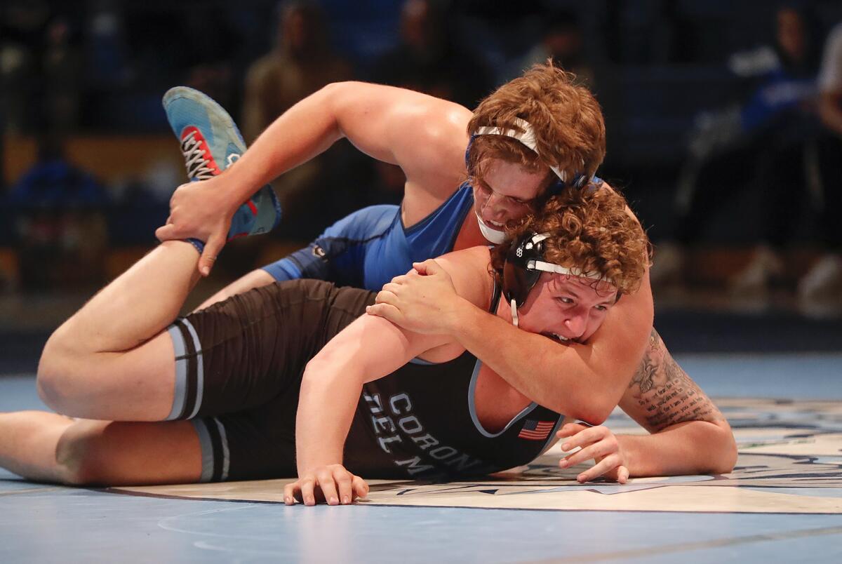 Fountain Valley's Caine Elroy tries to get a pin on Corona del Mar's Tony Leon.