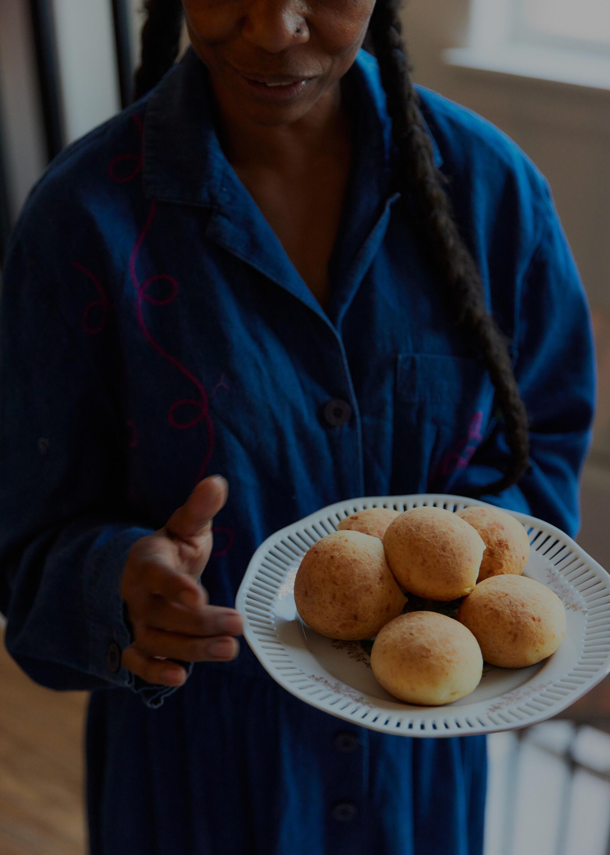 A plate of pão de queijo, fresh out of the oven.