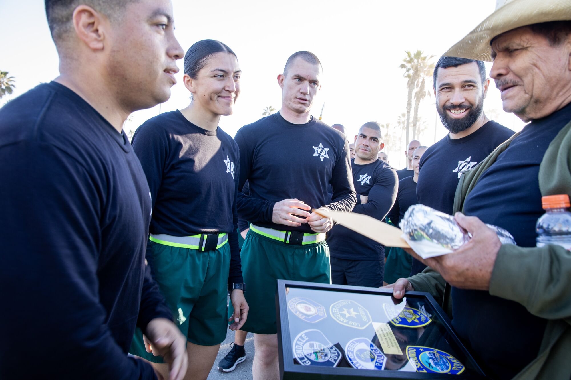 Recruits present a plaque to father and brother of fallen Monterey Park police officer Gardiel Solorio
