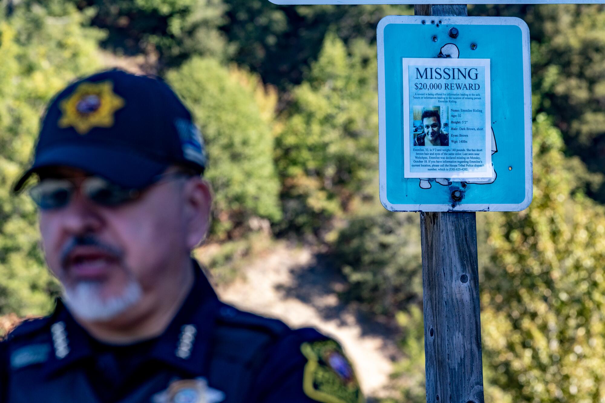 Greg O'Rourke stands near a post with a missing-persons sign