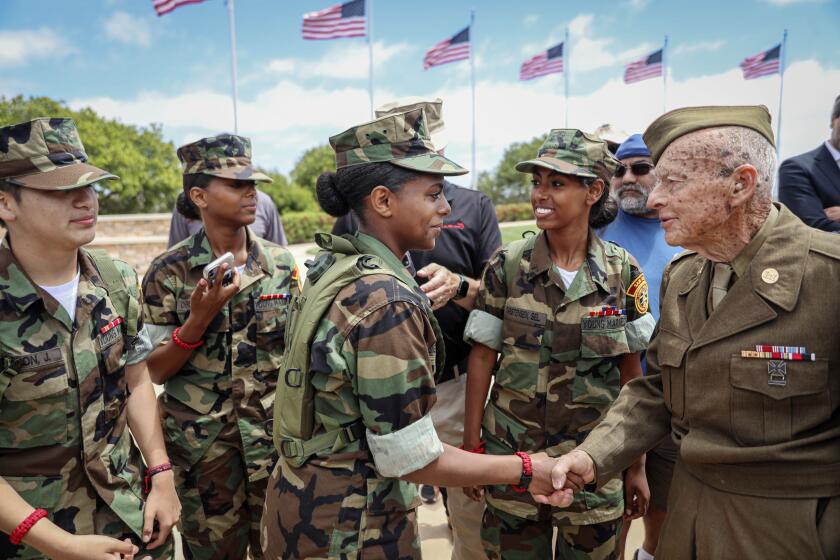 Members of the San Diego Young Marines, including Mara Christensen, shake hands and meet with Army WWII veteran Andre Chappaz, 97, during the 13th Annual Miramar Cemetery Memorial Day Event on Sunday, May 26, 2024.The Event was in honor of the over 1.2 million American men and women who have made the ultimate sacrifice defending our country and a special program to honor the 80th anniversary of D-Day.(Photo by Sandy Huffaker for The SD Union-Tribune)
