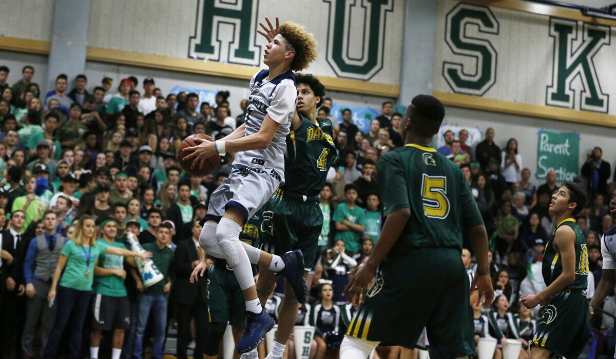 Chino Hills' LaMelo Ball (1) drives to the basket against Damien's Ashton Sharma (4) and Ezekiel Alley (5) in the second half in Chino Hills on Jan. 10.