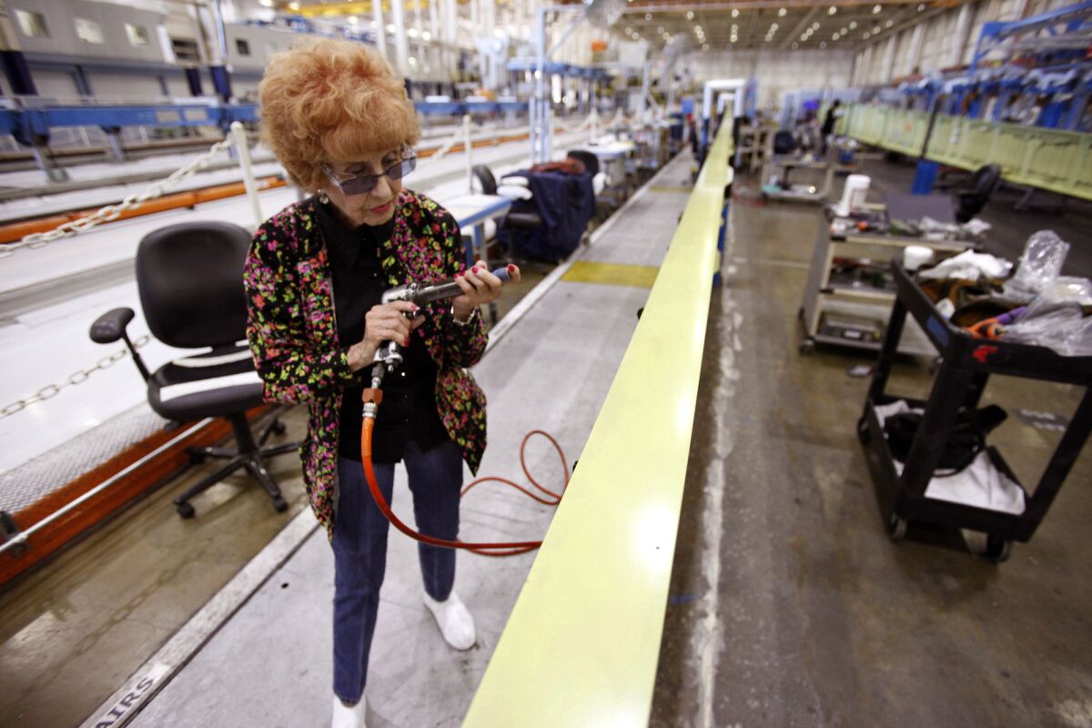 Elinor Otto, 93, prepares to rivet a wing while working at Boeing in Long Beach. "Don't get in her way, she'll run you over," a co-worker says.