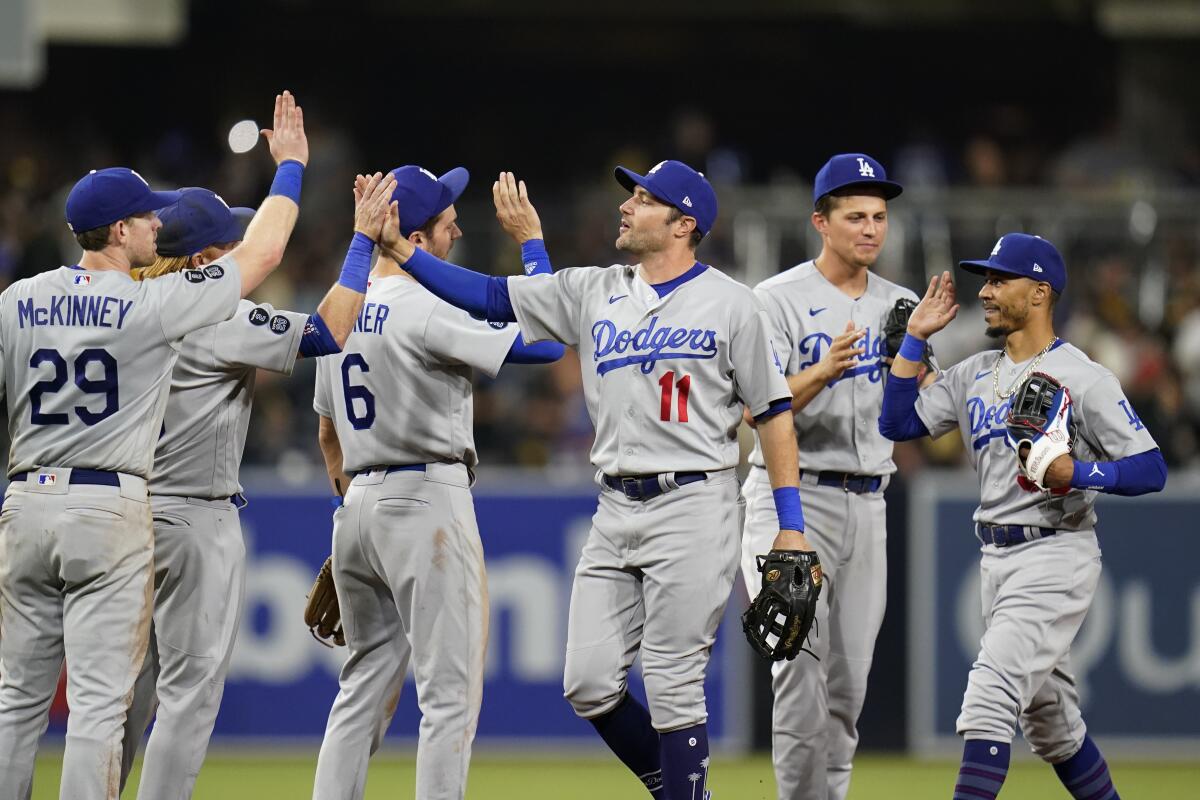 Dodgers left fielder AJ Pollock celebrates with teammates after the Dodgers defeated the San Diego Padres.