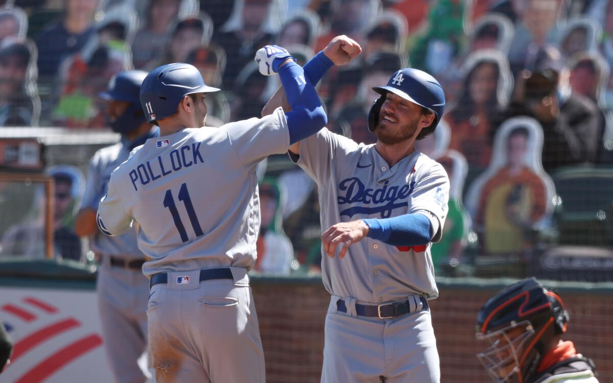 Dodgers' A.J. Pollock is congratulated by Cody Bellinger.
