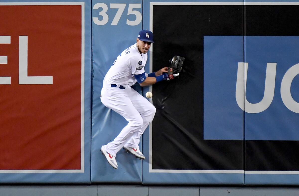 Dodgers center fielder Cody Bellinger crashes into the wall on an RBI double by Nationals Anthony Rendon in the 2nd inning.