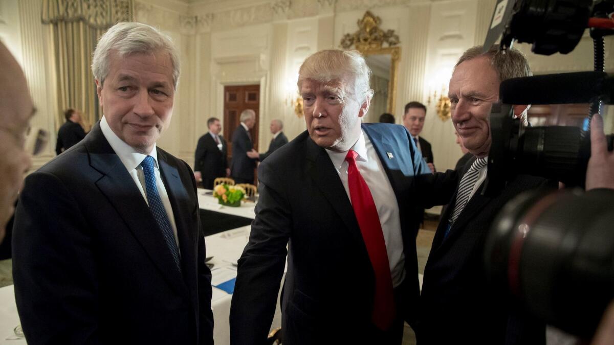 Jamie Dimon, left, chief executive of JPMorgan Chase & Co., joins President Trump before a White House forum with business leaders on Feb. 3.