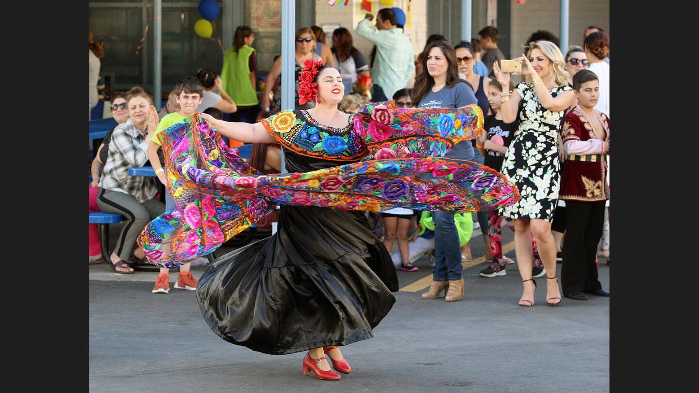 A dancer with Carolina Russek performs at Balboa Elementary School for the International Day Festival in Glendale on Friday, September 29, 2017. Bands and dancers entertained the attendees, and there were about a dozen vendors selling soaps, artwork, colored sand, food, and more.
