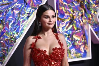 Selena Gomez arrives at the MTV Video Music Awards in a red gown