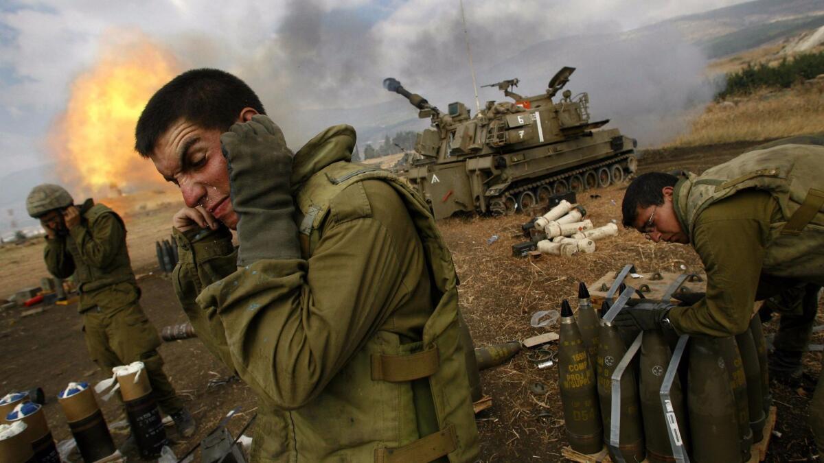Israeli soldiers react as artillery shells are fired into Lebanon during the 2006 war with Hezbollah.