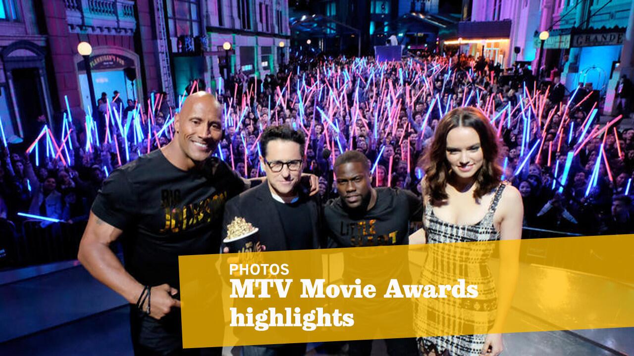 Writer-director J.J. Abrams, second from left, and actress Daisy Ridley accept Movie of the Year award for "Star Wars: The Force Awakens" with co-hosts Dwayne Johnson, left, and Kevin Hart.