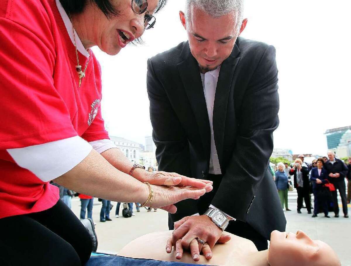 People in need of CPR were more likely to get help from a bystander when researchers deployed a mobile phone alert system. Above, a man learns CPR.