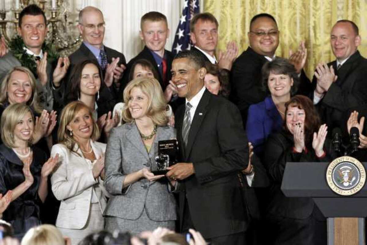 President Barack Obama presents the 2012 National Teacher of the Year award to Rebecca Mieliwocki, who teaches at Luther Burbank Middle School in Burbank, Calif., Tuesday during a ceremony in the East Room at the White House in Washington.