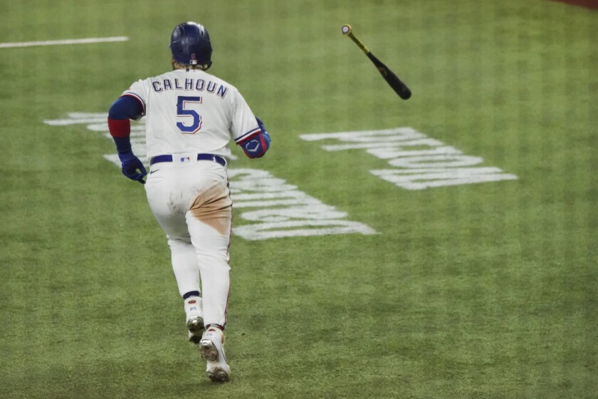 Texas Rangers designated hitter Willie Calhoun tosses the bat away after hitting a home run in the sixth inning of a baseball game against the Boston Red Sox in Arlington, Texas, Saturday, May 1, 2021. (AP Photo/Louis DeLuca)