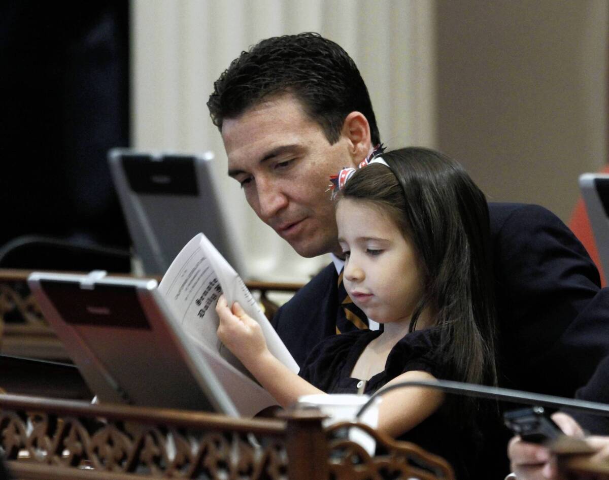 State Sen. Michael J. Rubio, shown with his daughter Iliana in 2011, resigned from office Friday to accept a government-affairs job with Chevron Corp.