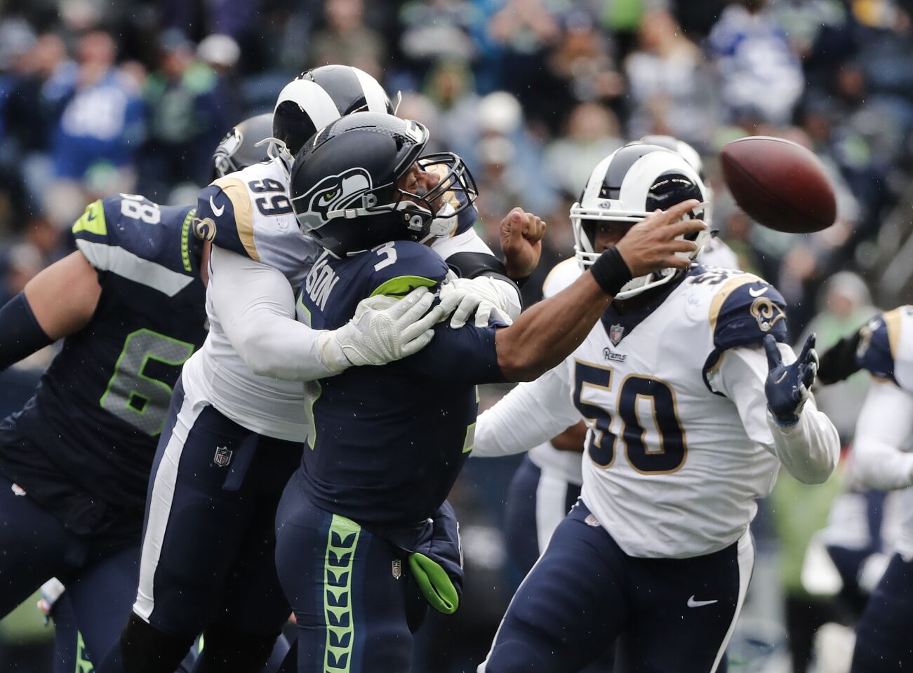 Rams defensive tackle Aaron Donald (99) sacks Seattle Seahawks quarterback Russell Wilson (3) in the second half at CenturyLink Field on Sunday in Seattle.