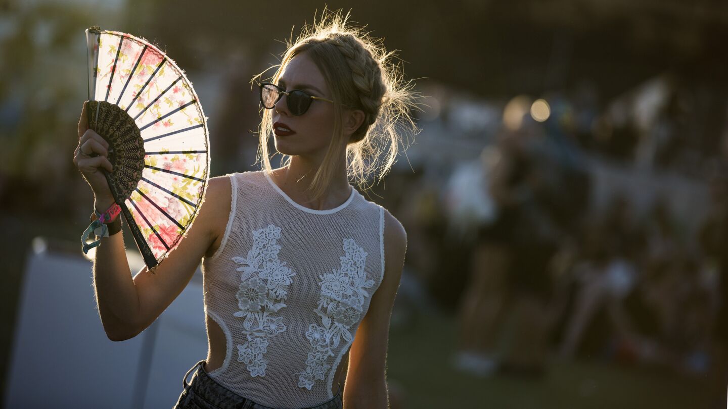 Aubrie Penk, 25, of San Diego keeps cool while waiting for Edward Sharpe and the Magnetic Zeros to perform on the Outdoor Theatre stage.