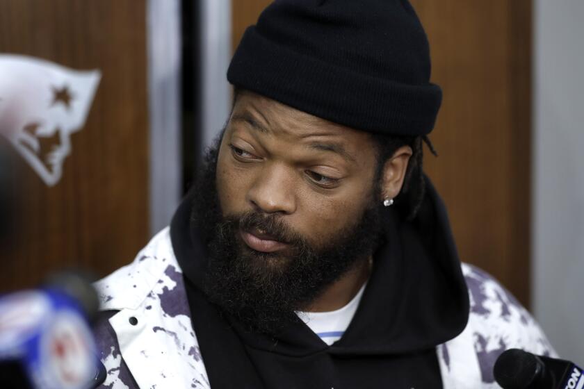 New England Patriots defensive lineman Michael Bennett speaks with members of the media in the team's locker room following an NFL football practice, Wednesday, Oct. 23, 2019, in Foxborough, Mass. (AP Photo/Steven Senne)