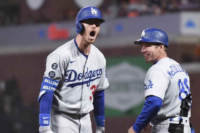 San Francisco, CA - October 14: Los Angeles Dodgers' Cody Bellinger, left, yells to the dugout after hitting.