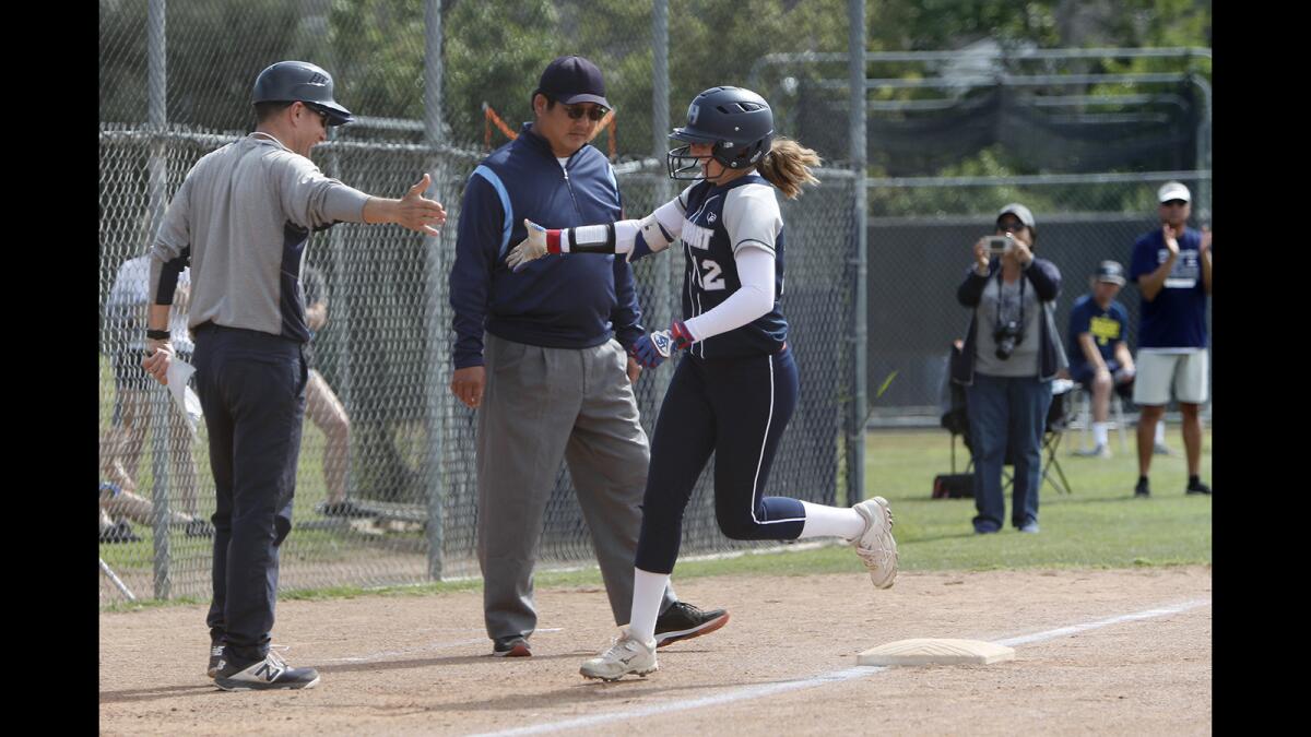 Newport Harbor coach Tom Blanchfield, left, high-fives Eliana Gottlieb after she hit a first-inning two-run home run against Ocean View in the first round of the CIF Southern Section Division 5 playoffs on May 2 in Newport Beach.