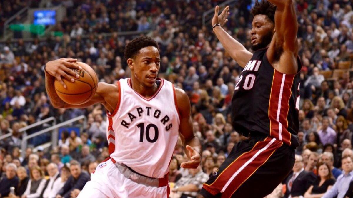 Raptors guard DeMar DeRozan drives around Miami forward Justise Winslow during the first half of a game on Nov. 4.