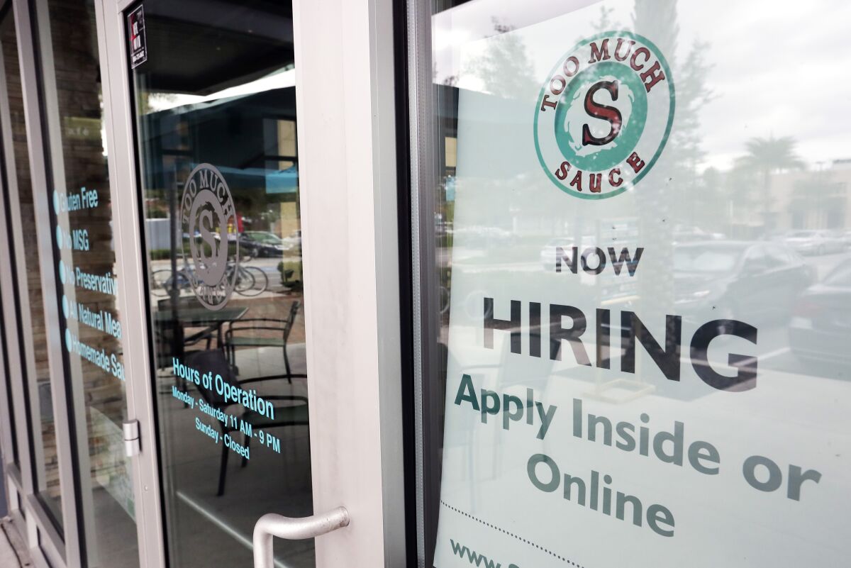 FILE - In this Nov. 4, 2019 file photo a job posting is displayed near the entrance outside a restaurant in Orlando, Fla. 