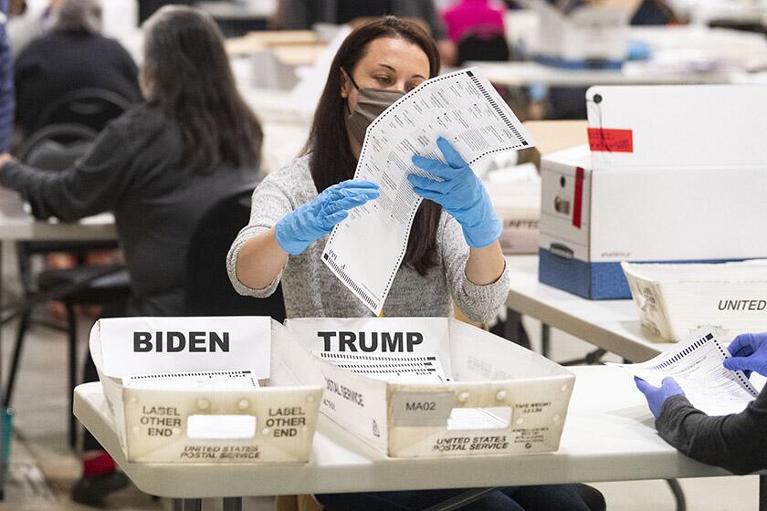 An election worker takes part in a hand recount of presidential votes in Marietta, Ga.