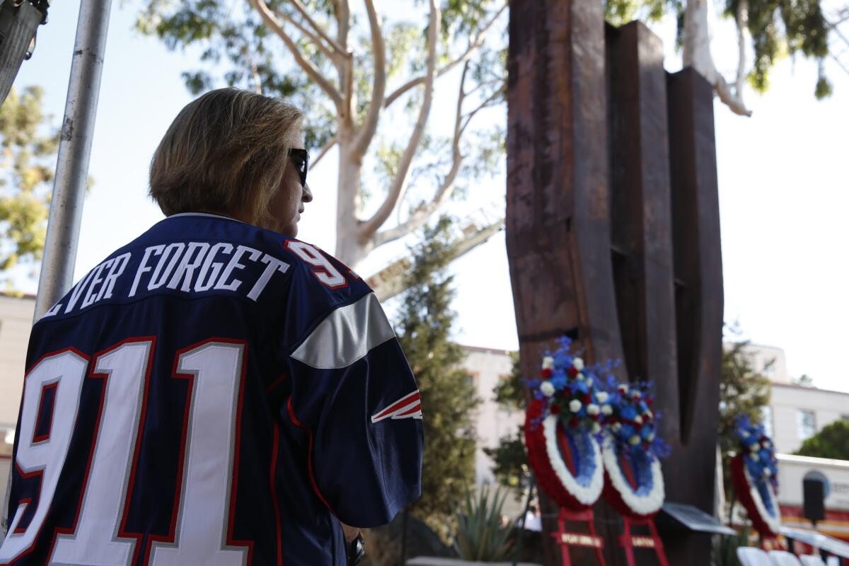 Carolyn Garnica of Murrieta stands in front of the World Trade Center Memorial at the LAFD Frank Hotchkin Memorial Training Center prior to a remembrance ceremony Thursday morning.