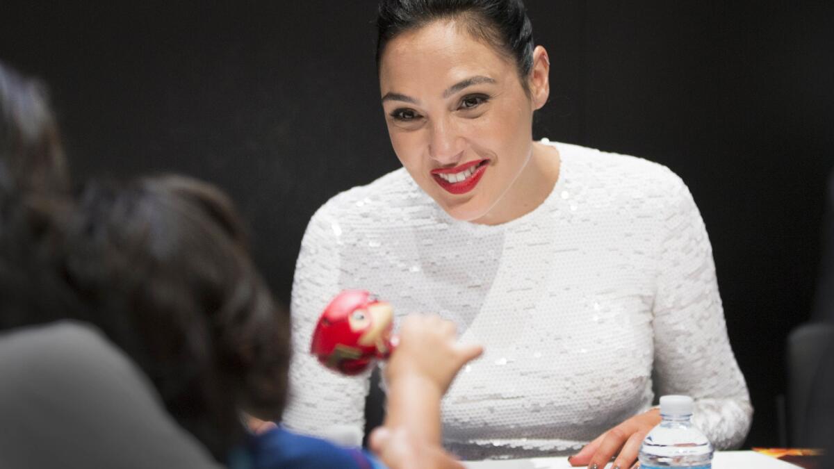 Actors Gal Gadot and Jason Momoa greet fans during the "Justice League" autograph signing July 22 at Comic-Con in San Diego.