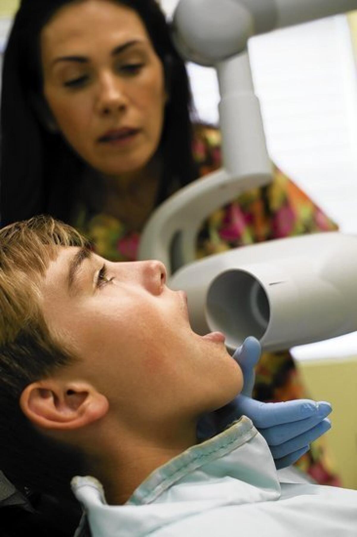 An X-ray machine is lined up on a young patient. Doctors say children are more vulnerable to radiation exposure.