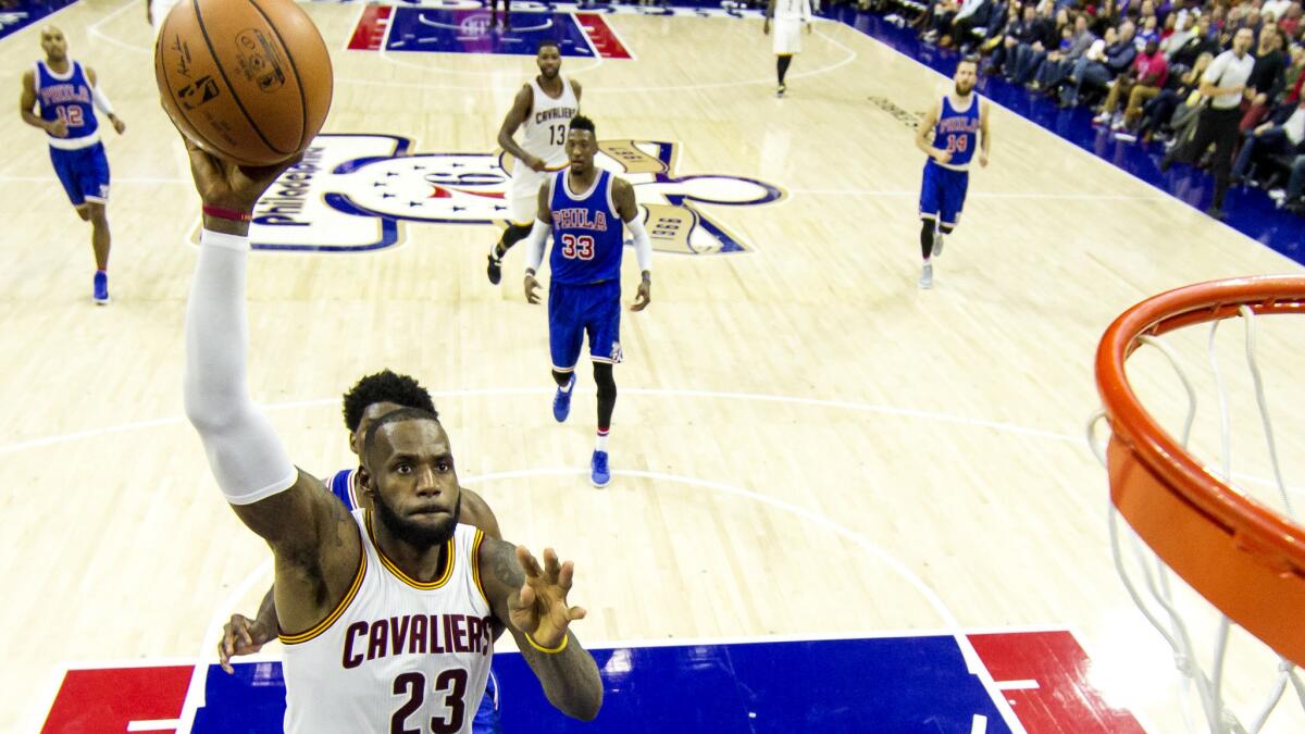 Cavaliers forward LeBron James goes up for the dunk against the 76ers on Saturday.