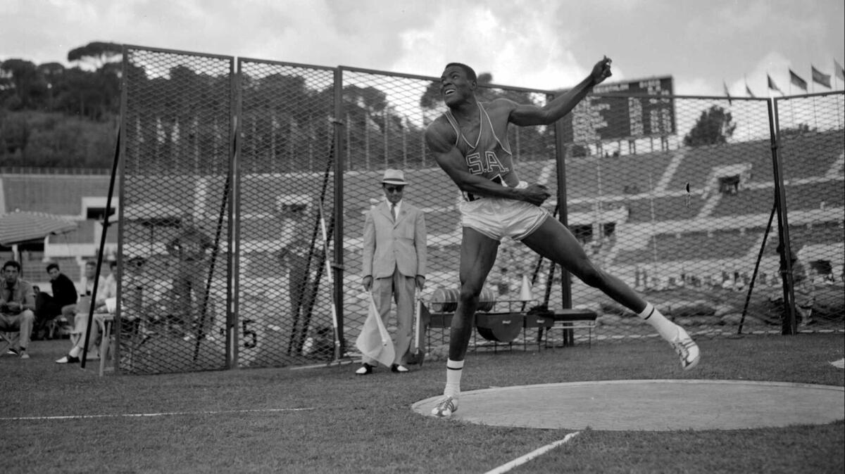 Rafer Johnson throws a discus while competing in decathlon at the 1960 Olympic Games in Rome.