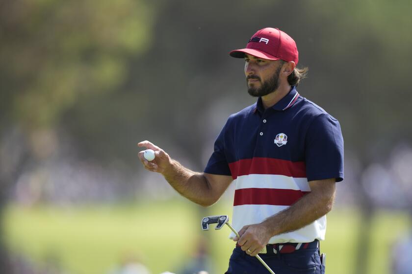 United States' Max Homa acknowledges the crowd on the 1st green during his singles match at the Ryder Cup golf tournament at the Marco Simone Golf Club in Guidonia Montecelio, Italy, Sunday, Oct. 1, 2023. (AP Photo/Andrew Medichini)